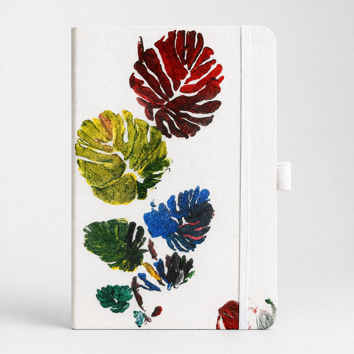 Notebook with colorful leaf design on a white background