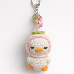 Crocheted duck keychain with a pink bow 